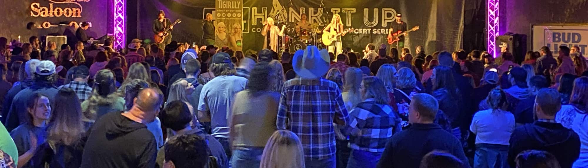 country concert with fans wearing cowboy hats Wilmington